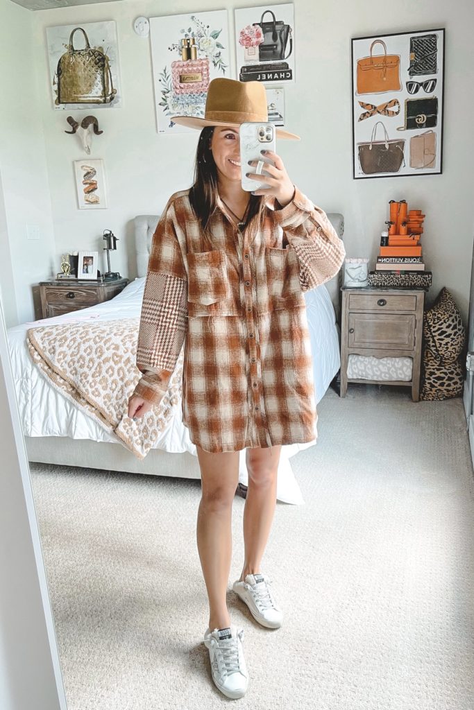 rust plaid flannel dress with lack of color hat and golden goose sneakers
