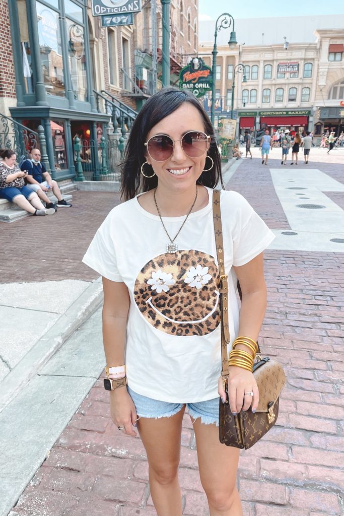 leopard smiley tee with agolde denim shorts and louis vuitton pochette metis