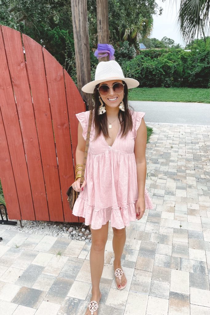 pink romper with white hat and budhagirl bracelets