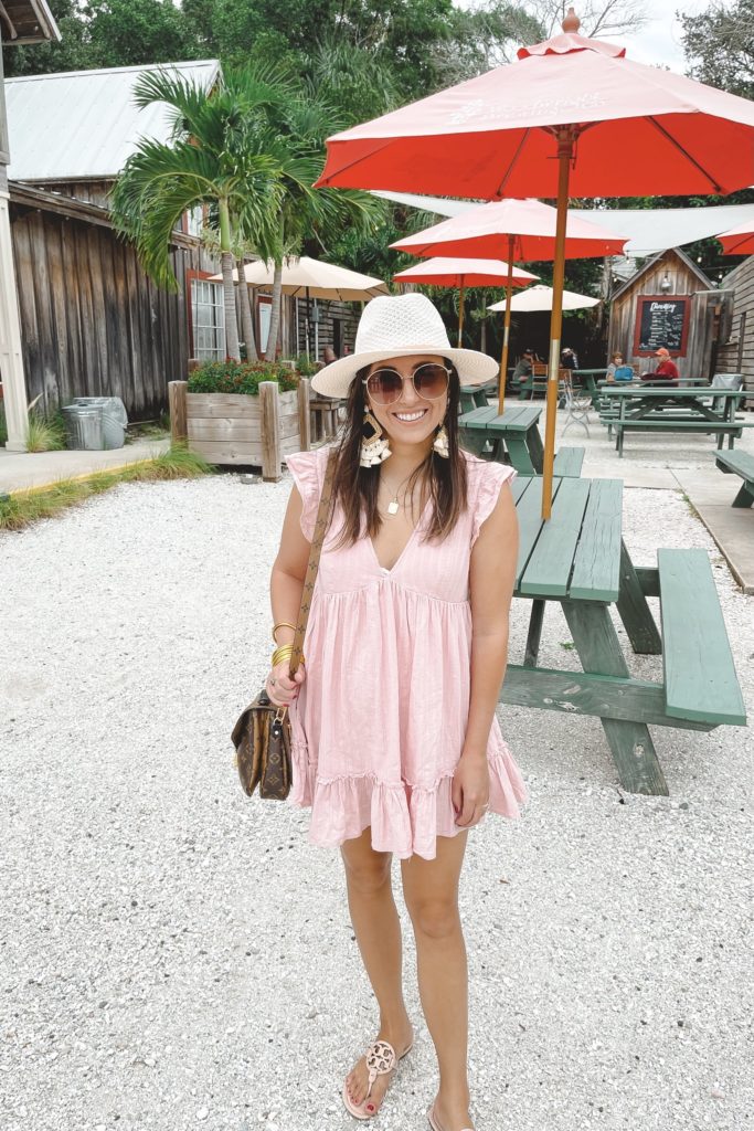 pink romper with white hat at woodwright brewery