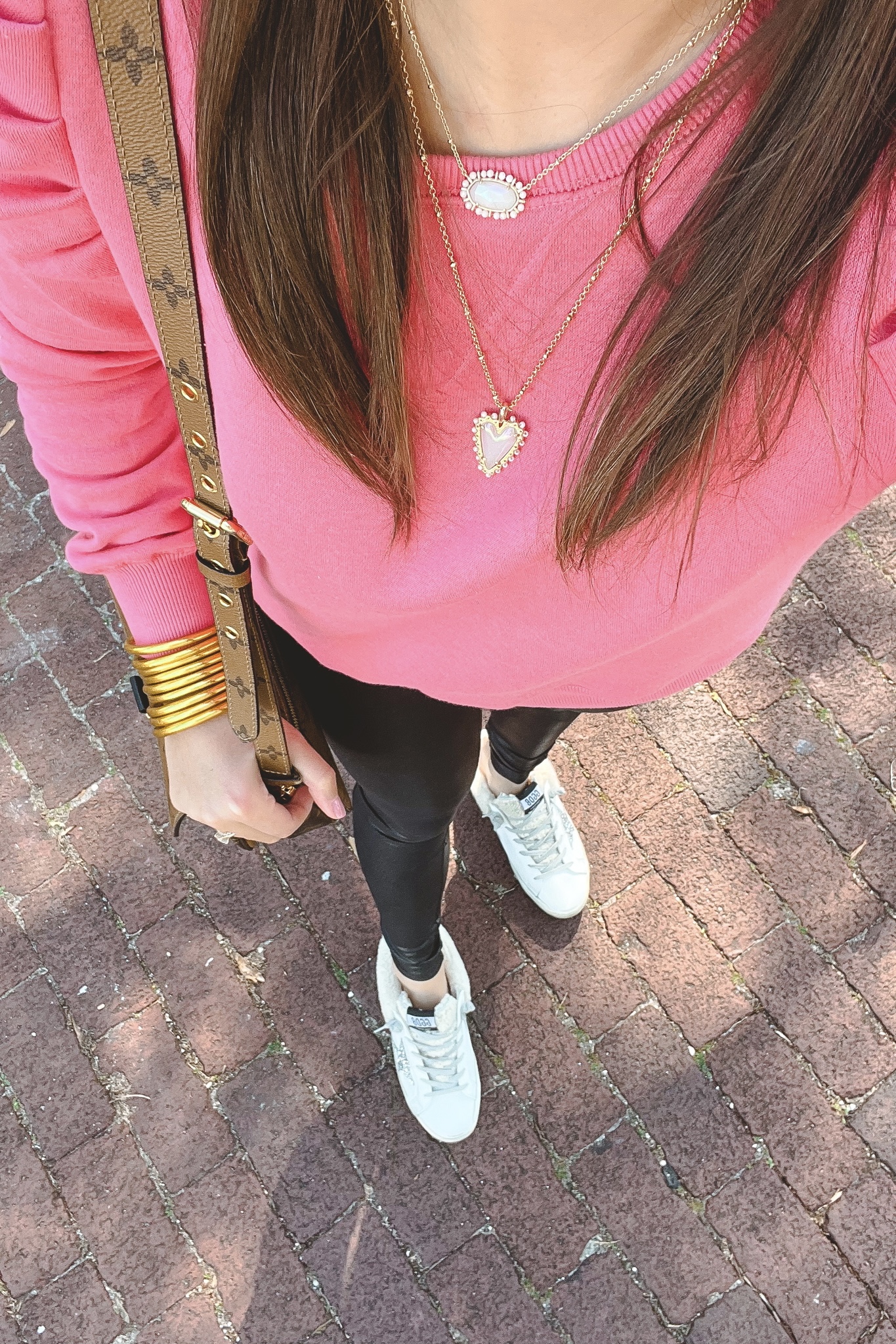 kendra scott layered heart necklaces with pink sweatshirt and faux leather leggings