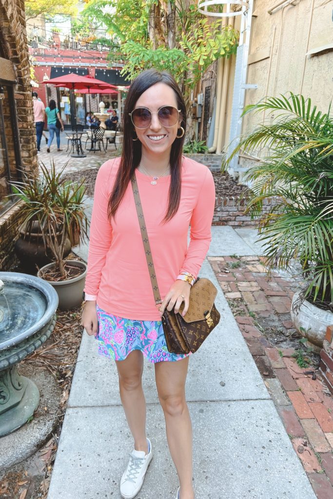 lilly pulitzer turtle skort with coral sun guard shirt and gucci sunglasses