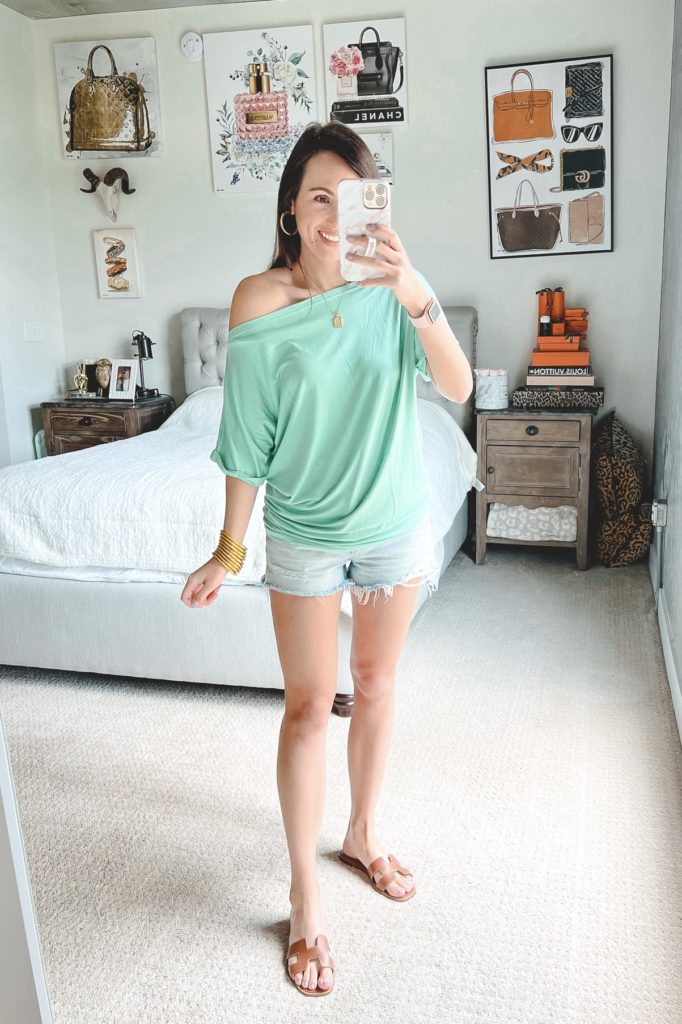 amazon green off the shoulder tee with agolde denim shorts and hermes oran sandals