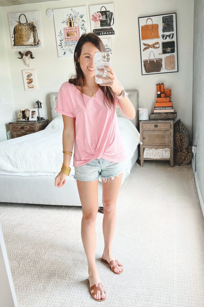 amazon pink twist front tee with agolde denim shorts and hermes oran sandals