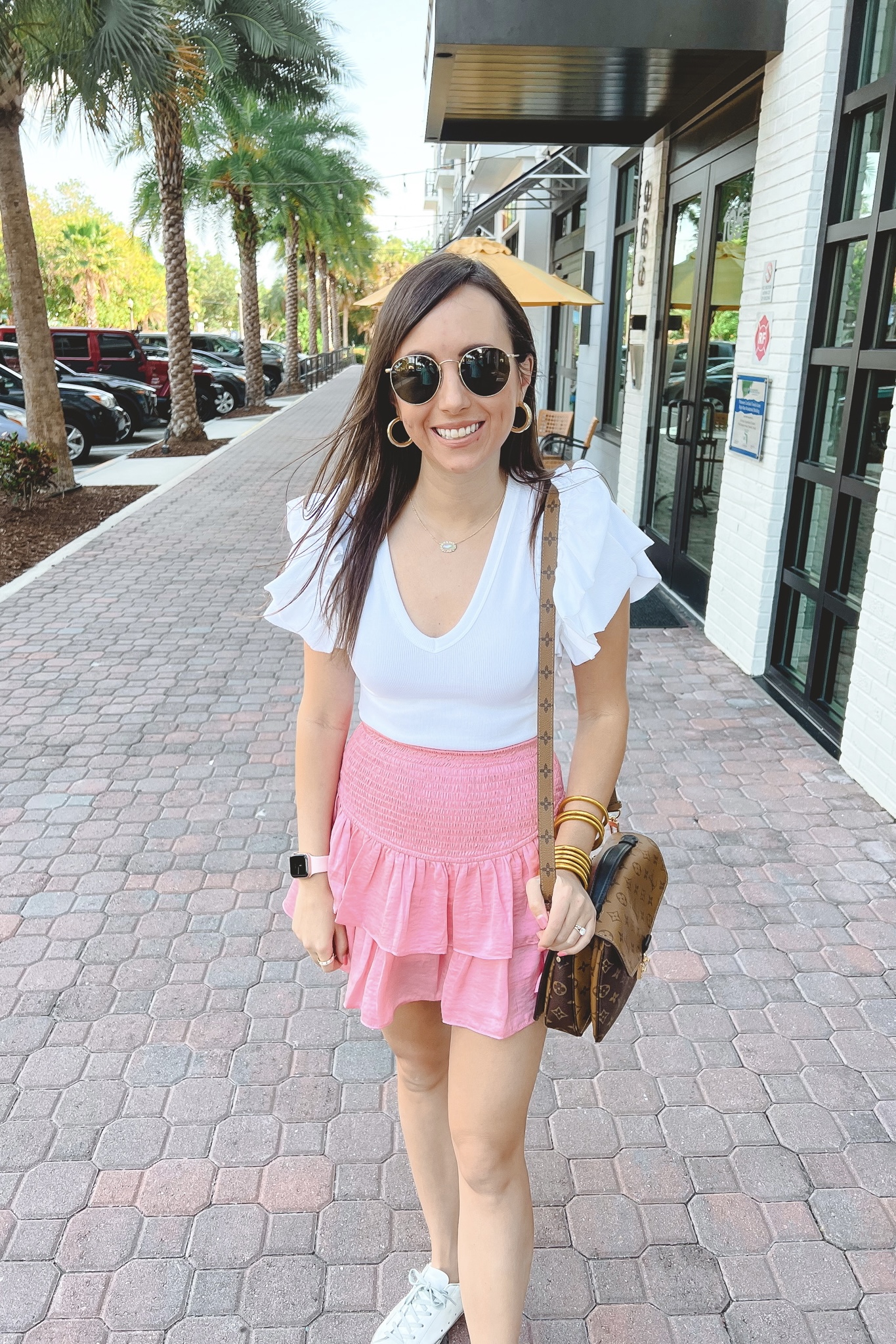 feeling flirty pink skort with express bodysuit and louis vuitton pochette metis