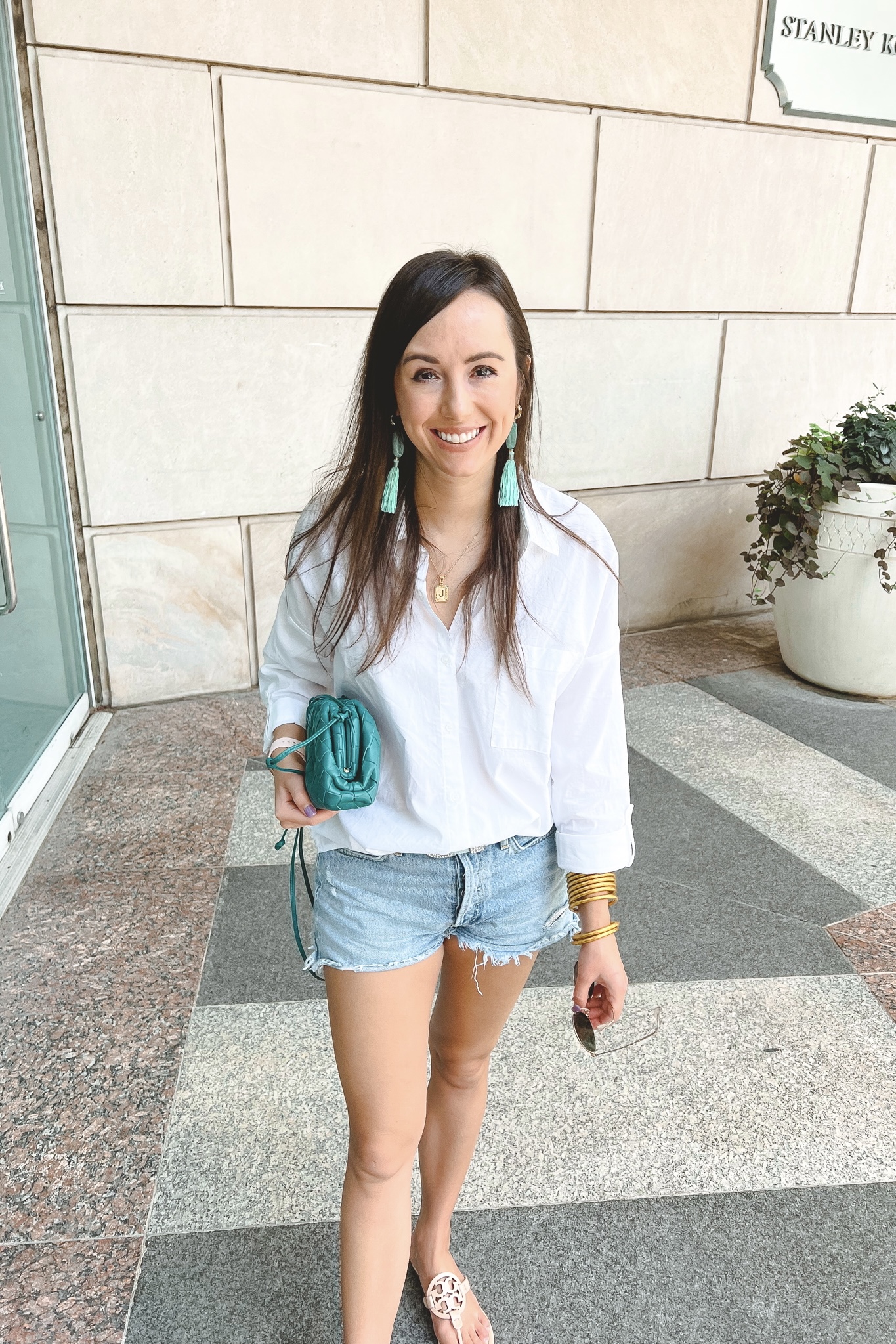 crisp white top with agolde denim shorts and kendra scott turquoise earrings