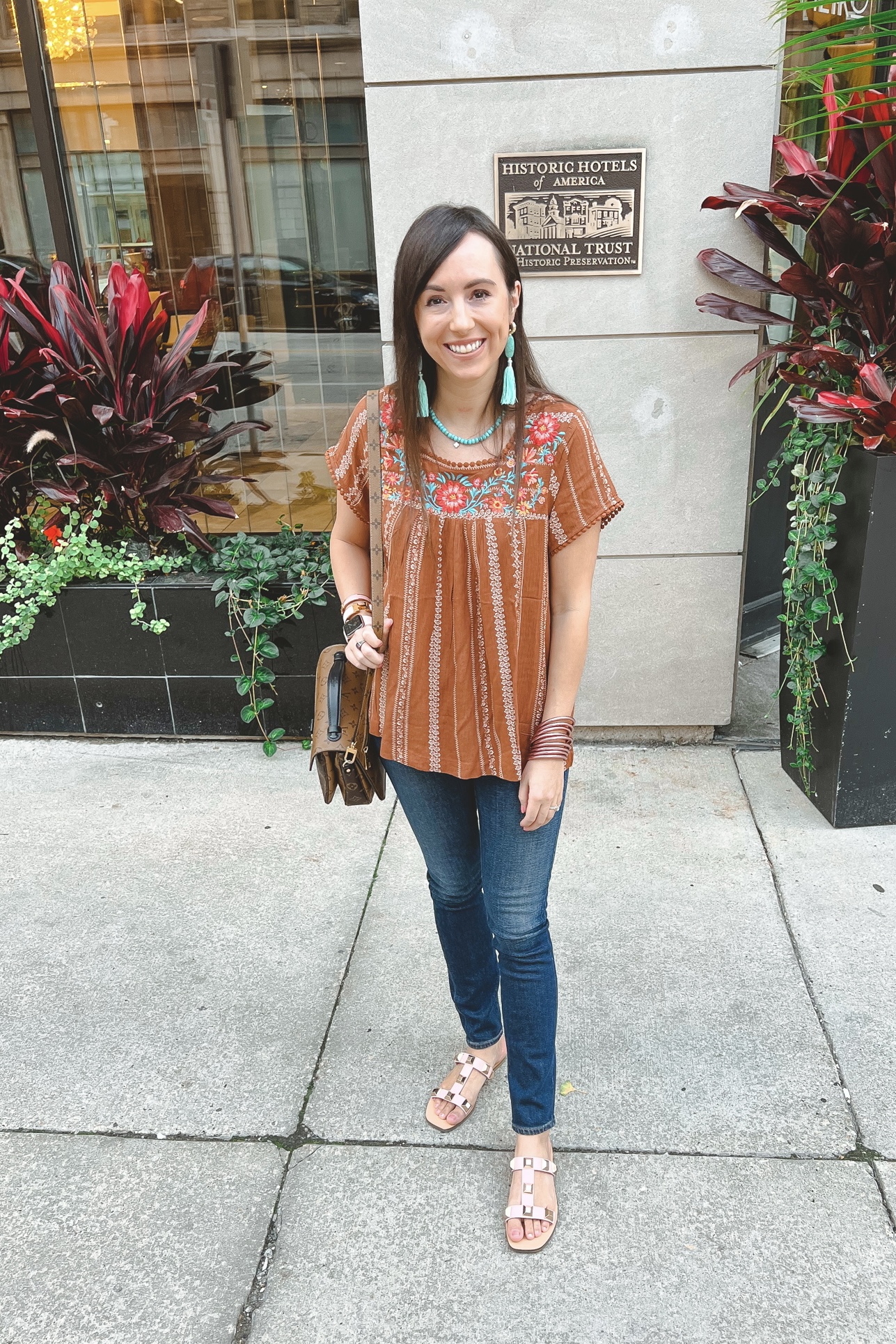 brown embroidered top with agolde jeans and turquoise jewelry
