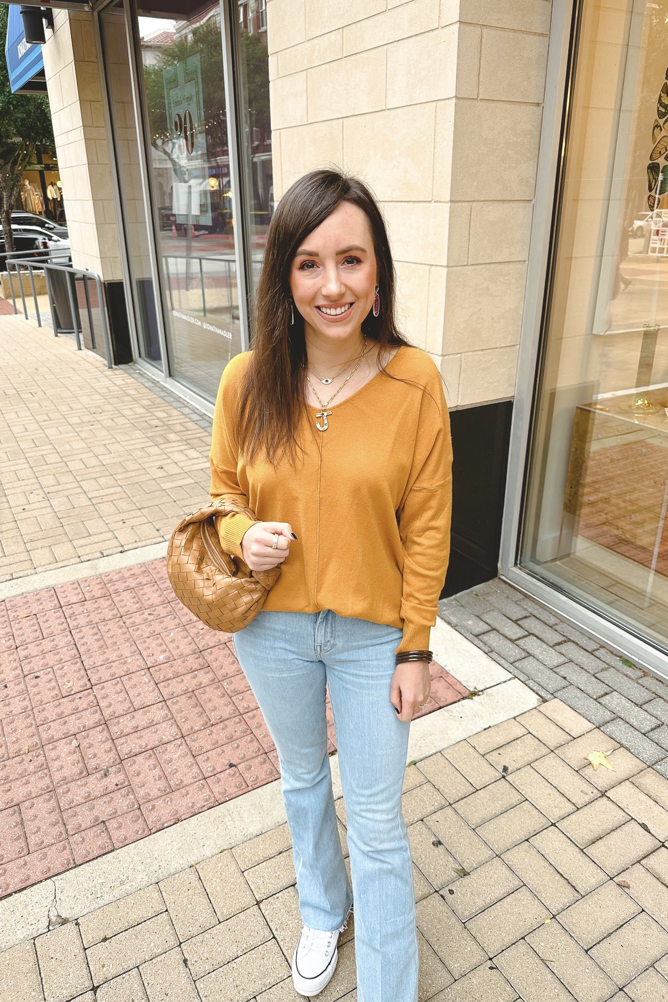 mustard sweater with mother weekender jeans and converse sneakers