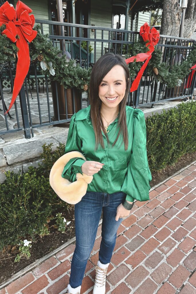 green silk blouse with dark denim and shearling bag