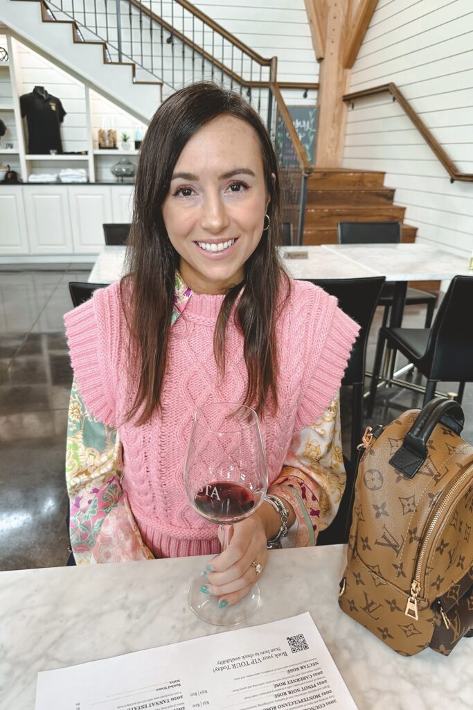 pink zara sweater vest with patchwork blouse at fredericksburg winery