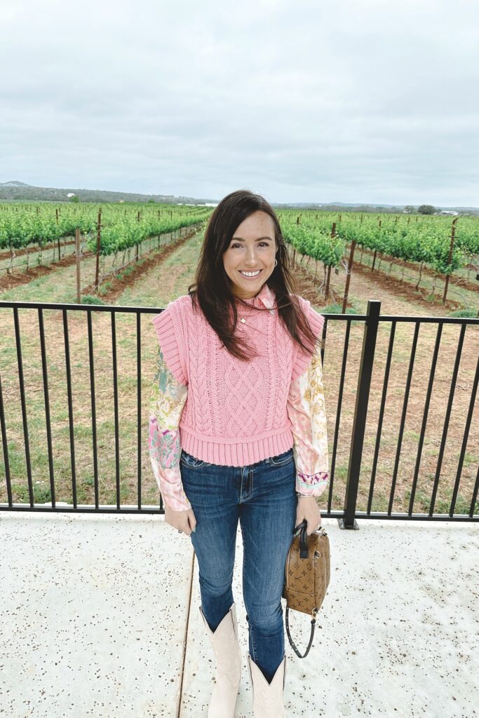 pink zara sweater vest with white cowgirl boots and louis vuitton palm springs mini