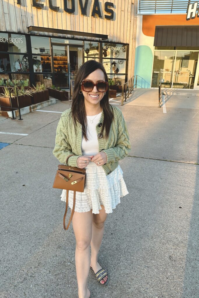 free people green bonfire cardigan with loveshackfancy ruffle skirt and hermes mini kelly dupe