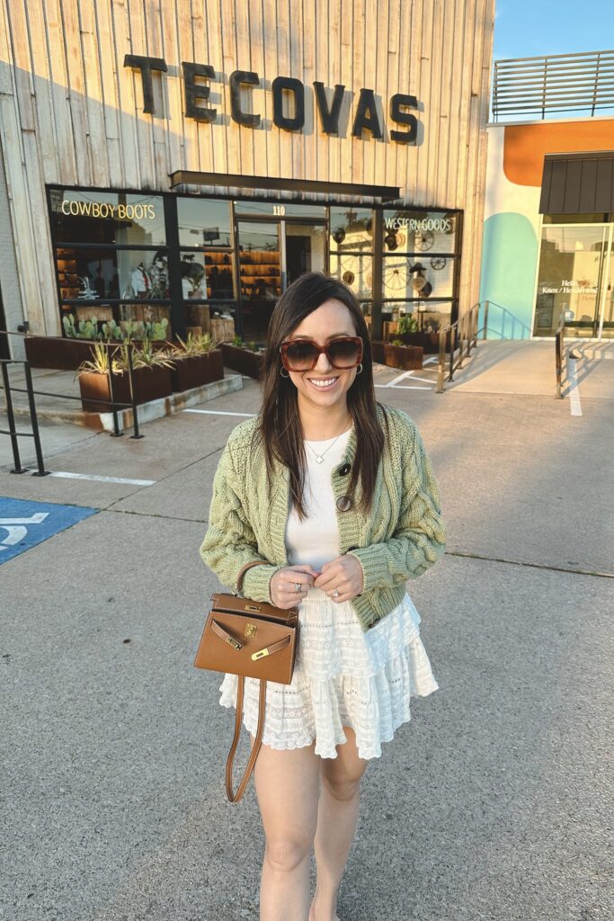 free people green bonfire cardigan with loveshackfancy ruffle skirt and gucci sunglasses