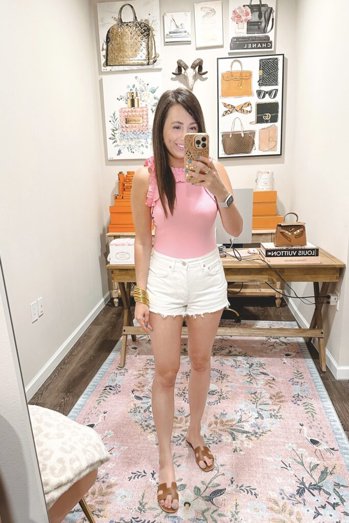 Amazon pink ruffle ribbed bodysuit with white shorts and hermes oran sandals