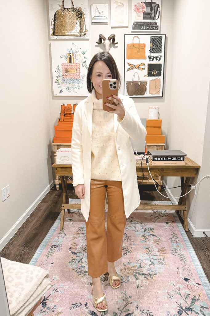 Cream double breasted coat with camel faux leather pants