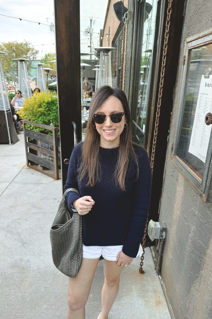 Vince navy cashmere sweater with 7 for all mankind white denim shorts and bottega veneta hobo