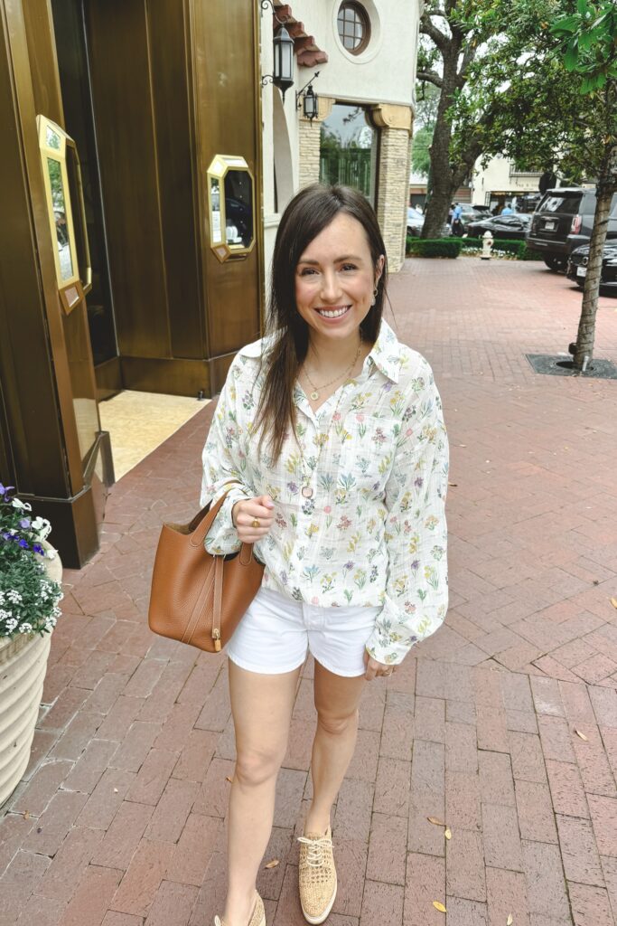 Floral spring ivory blouse with white agolde parker shorts and hermes gold picotin