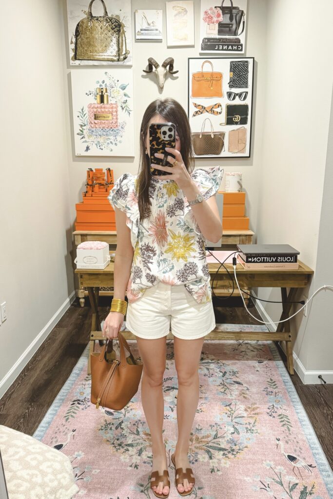 Red dress boutique ivory floral short sleeve top with agolde white parker shorts and hermes gold oran sandals