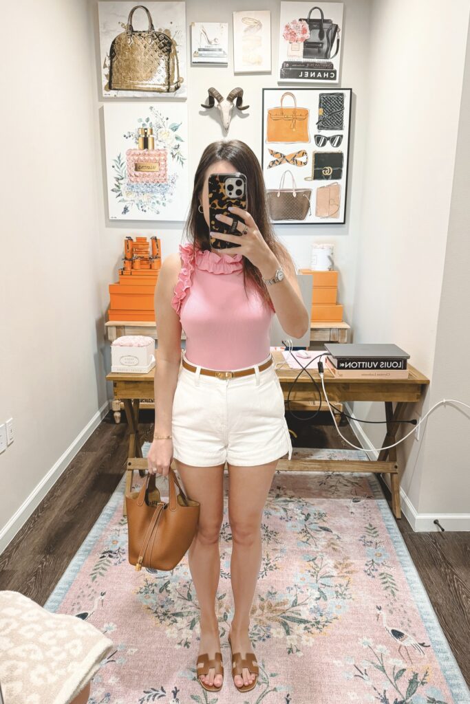 Amazon ruffle pink sleeveless bodysuit with white denim shorts and hermes kelly belt