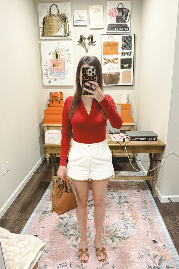 Amazon red collared bodysuit with white denim shorts and hermes gold picotin