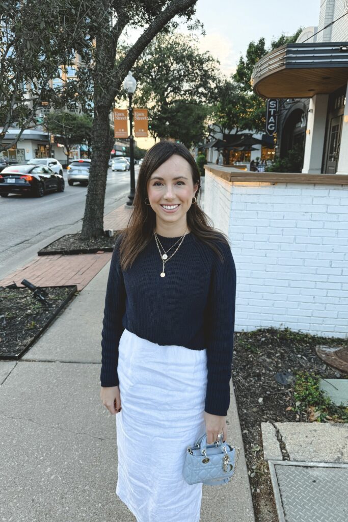 Navy sweater with white linen midi skirt and dior micro djoy