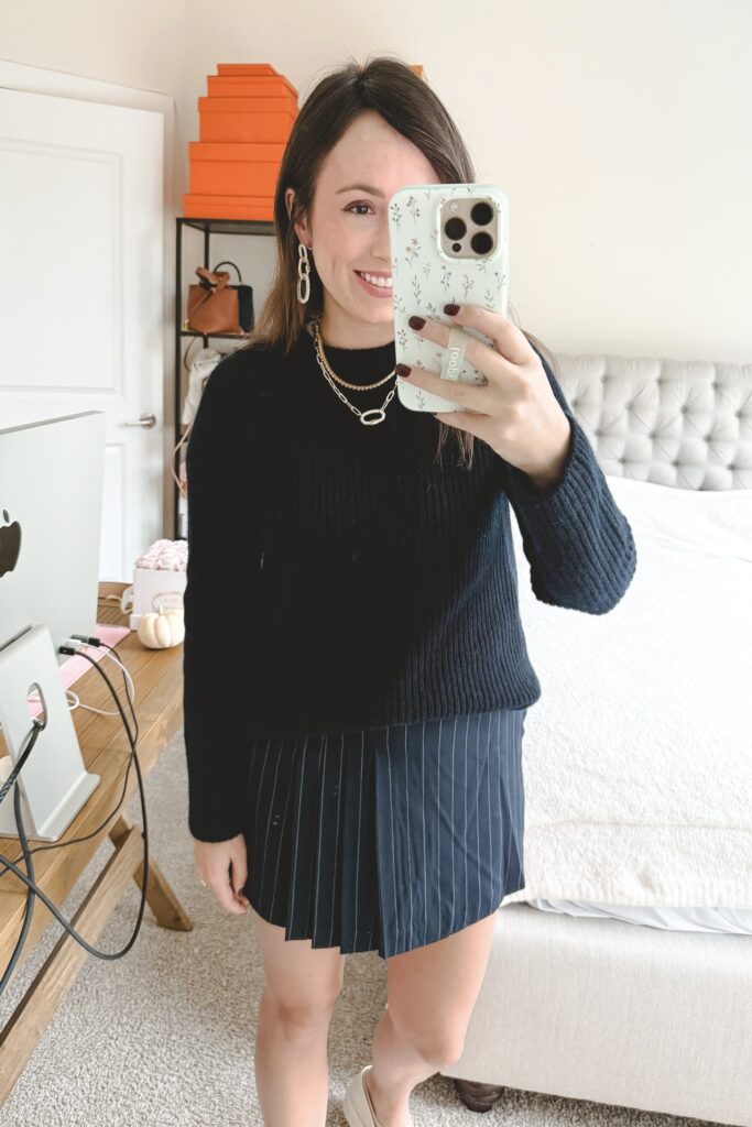 Navy cashmere sweater with navy pinstripe skort and kendra scott jewelry