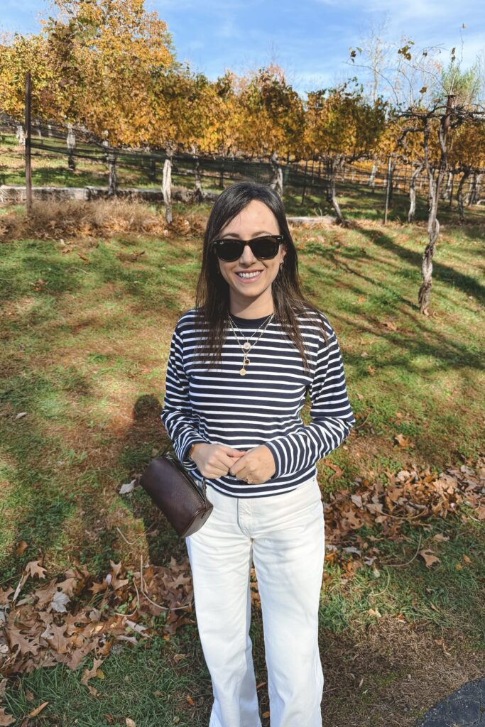 Navy long sleeve stripe tee with ecru baggy jeans and the row 90s brown bag