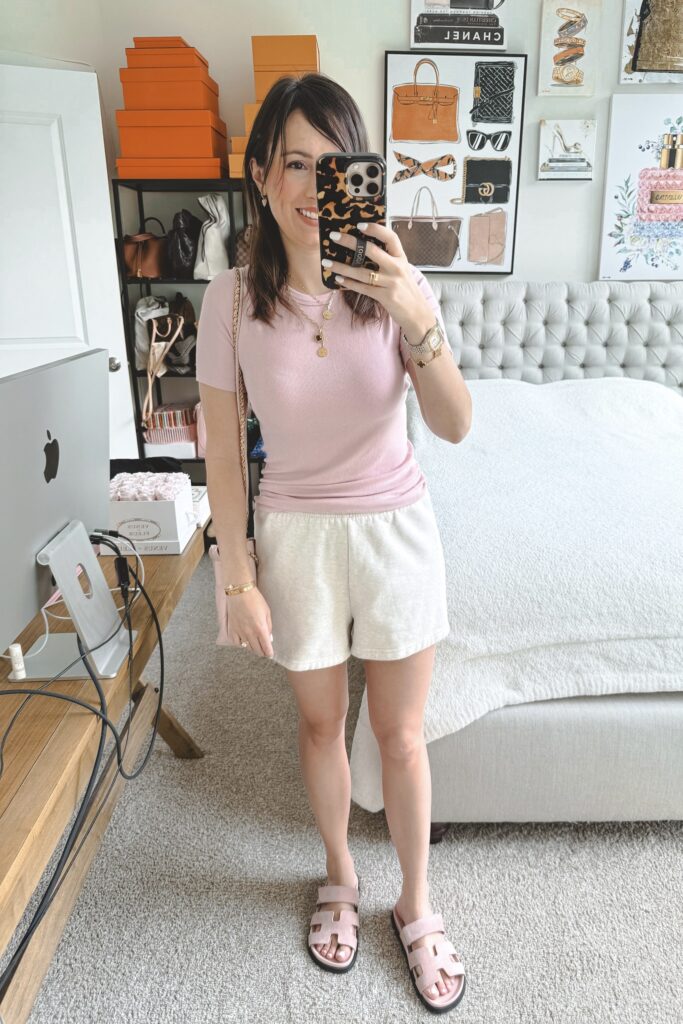 Lululemon hold tight tee pink haze with aritzia oatmeal fleece shorts and hermes chypre sandals