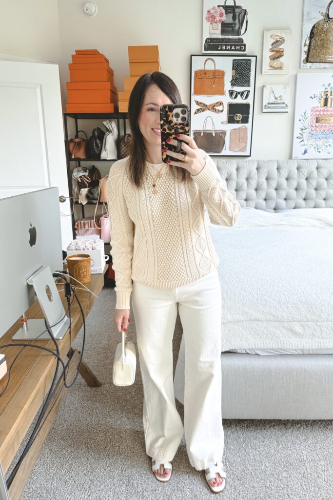 J Crew cream cable knit sweater with ecru jeans and white hermes oran sandals