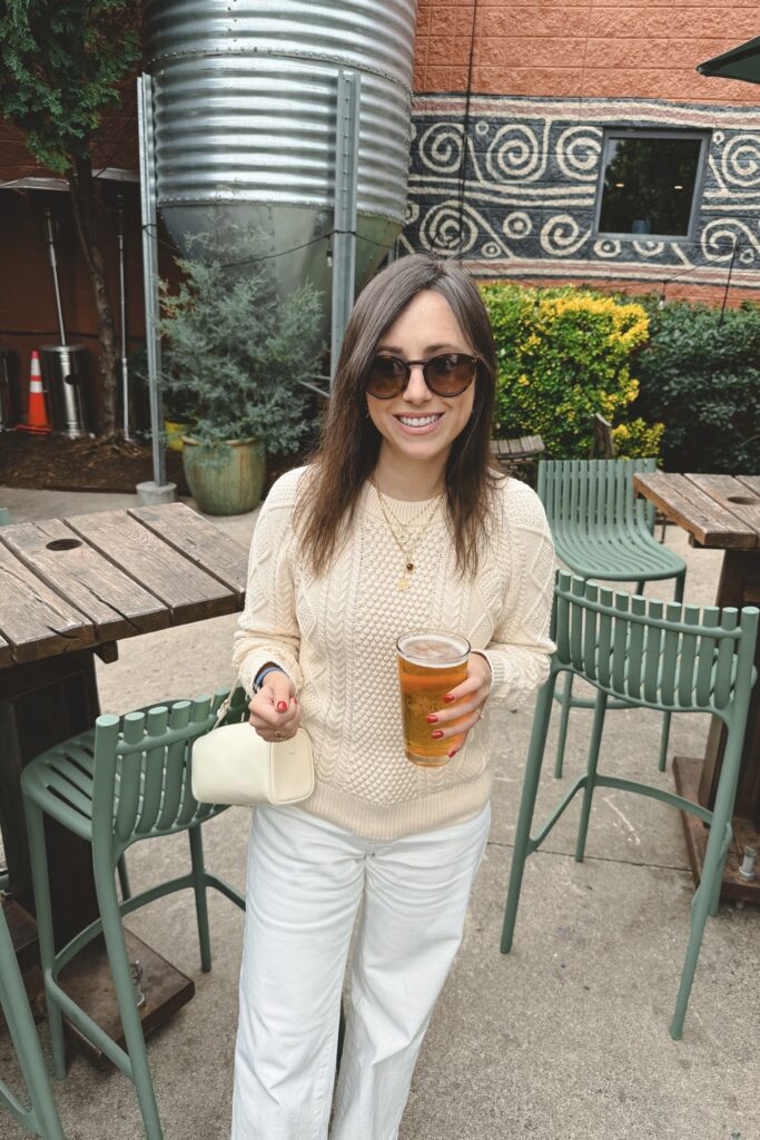 J Crew cream cable knit sweater with ecru baggy jeans and celine sunglasses