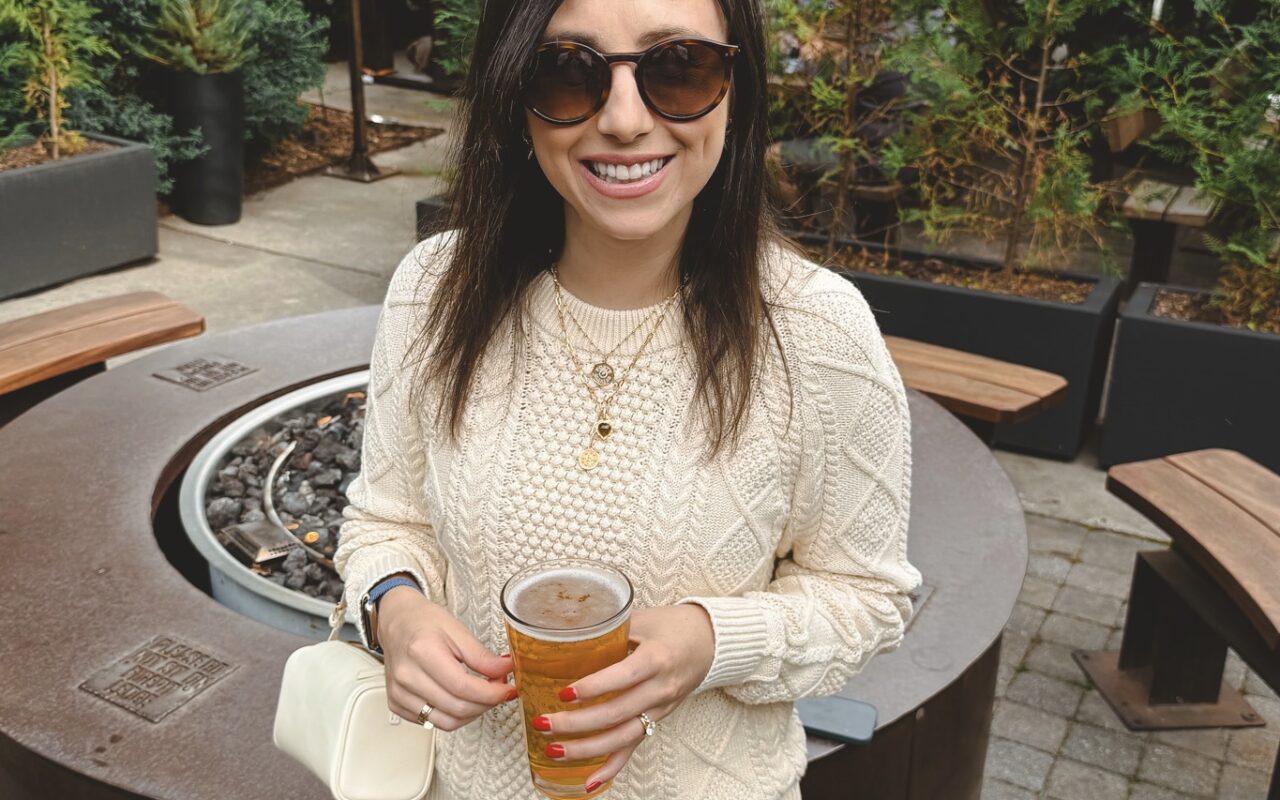 J Crew cream cable knit sweater with ecru baggy jeans and white the row 90s bag