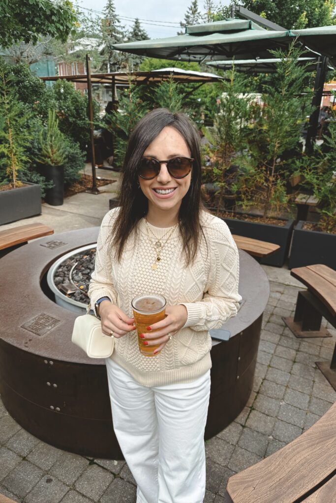 J Crew cream cable knit sweater with ecru baggy jeans and white the row 90s bag