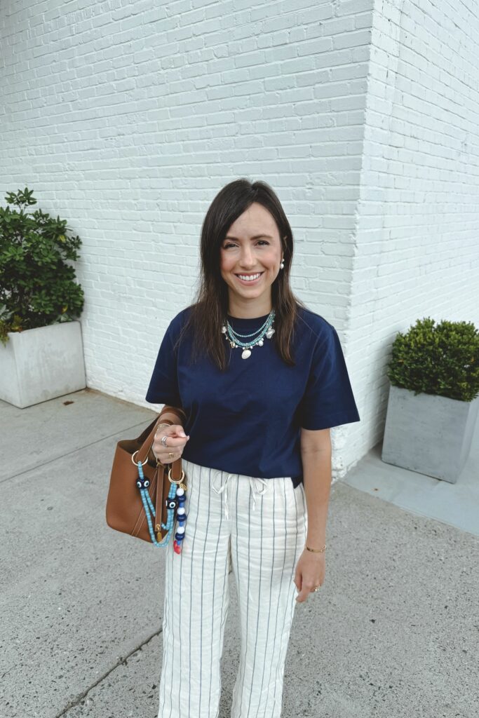 J crew navy boxy tee with stripe linen pants and hermes gold picotin