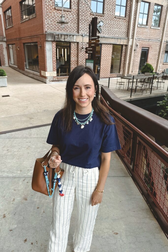 J crew navy boxy tshirt with stripe linen pants and gold hermes picotin