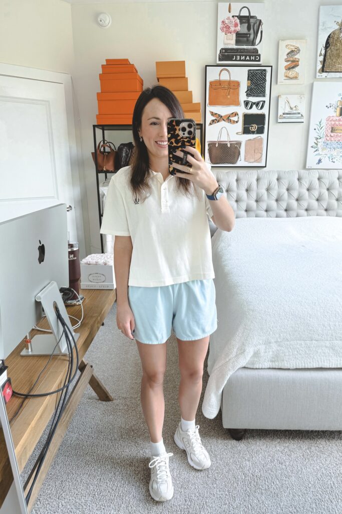 J crew white cropped polo with blue track shorts and new balance 530 sneakers